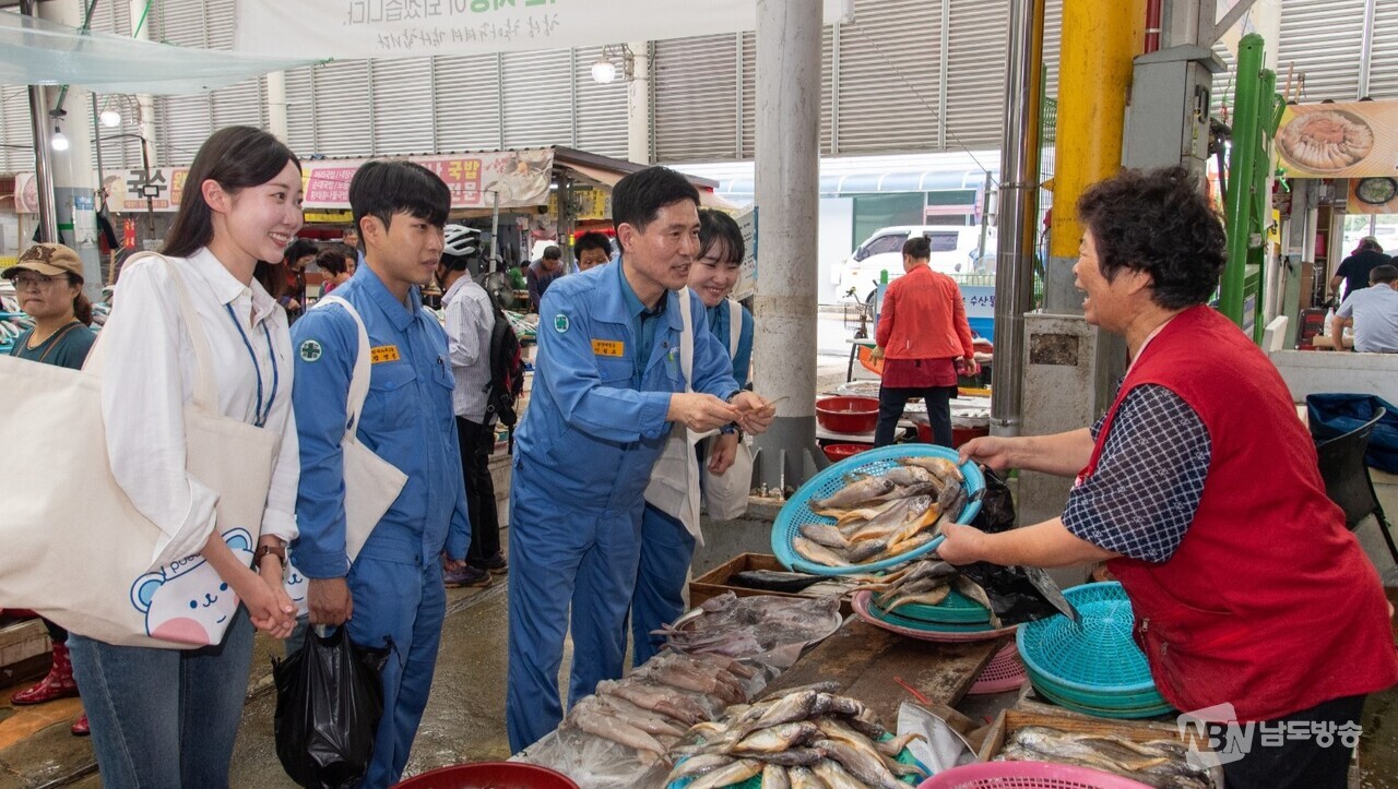▲이철호 광양제철소 부소장이 직원들과 함께 수산물을 구매하고 있는 모습 (사진=광양제철소)